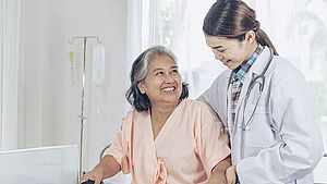 elderly-female-smiling-with-young-female-doctor-visiting-senior-patient-woman-hospital
